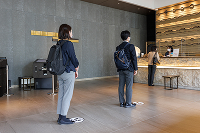 Maintaining physical distance in a queue at the front desk